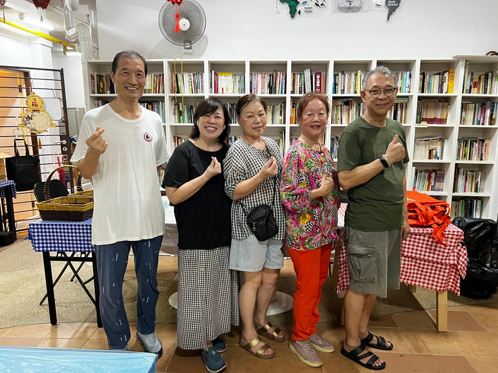Five neighbours together inside HV Little Library during Veggie Night