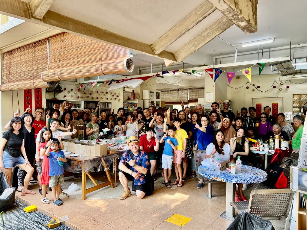 A large group of neighbours gathered inside HV Little Library beneath the void deck